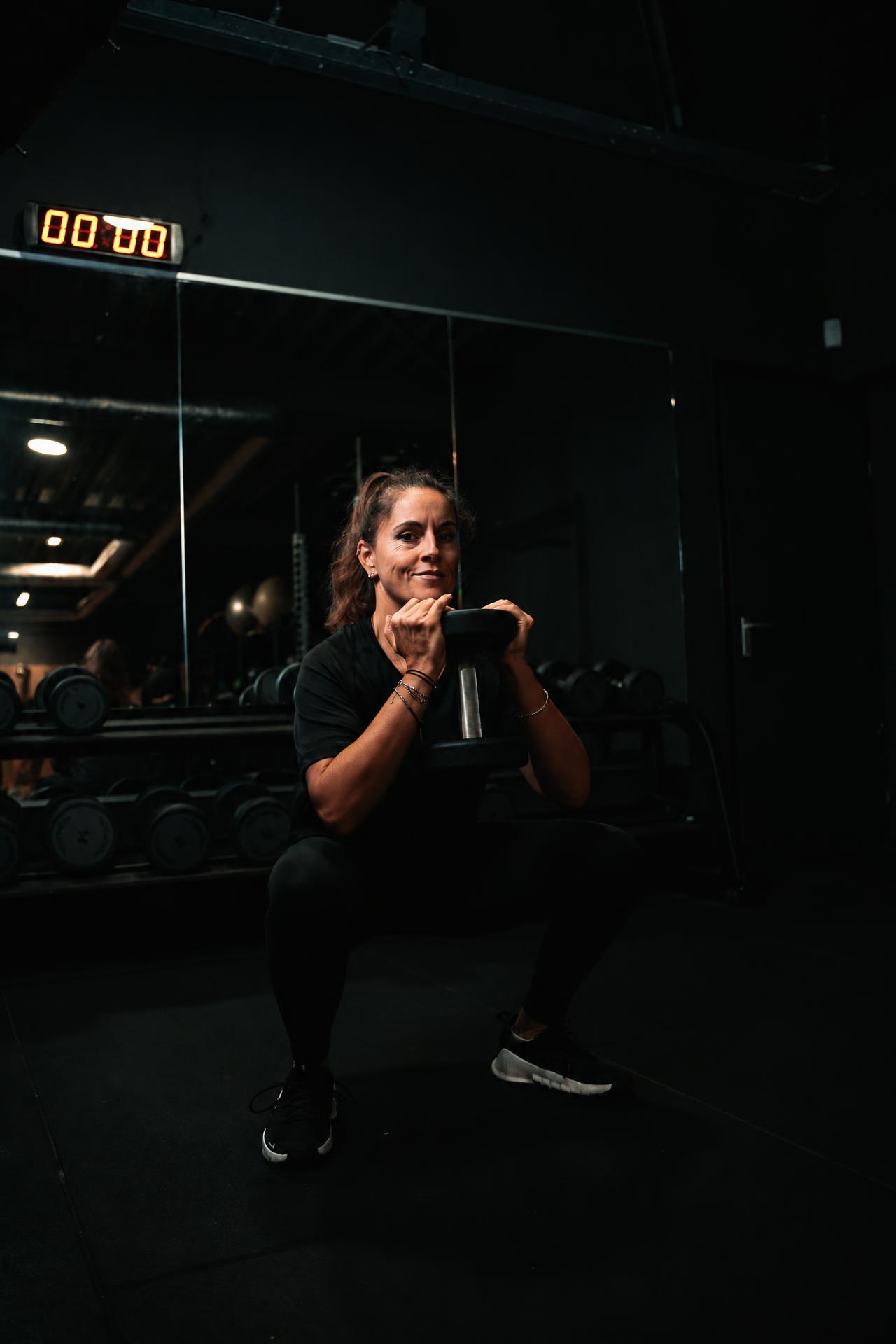 Deelnemer traint met een halter in de gym